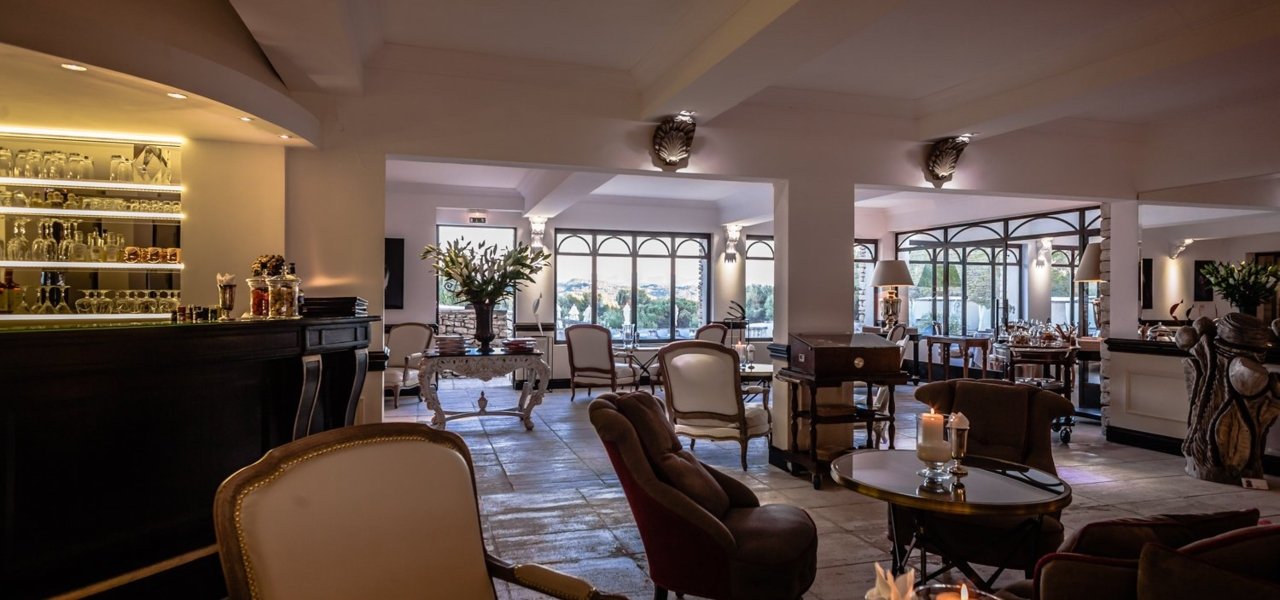 Le Phebus Bar with chairs and tables - Wine Paths